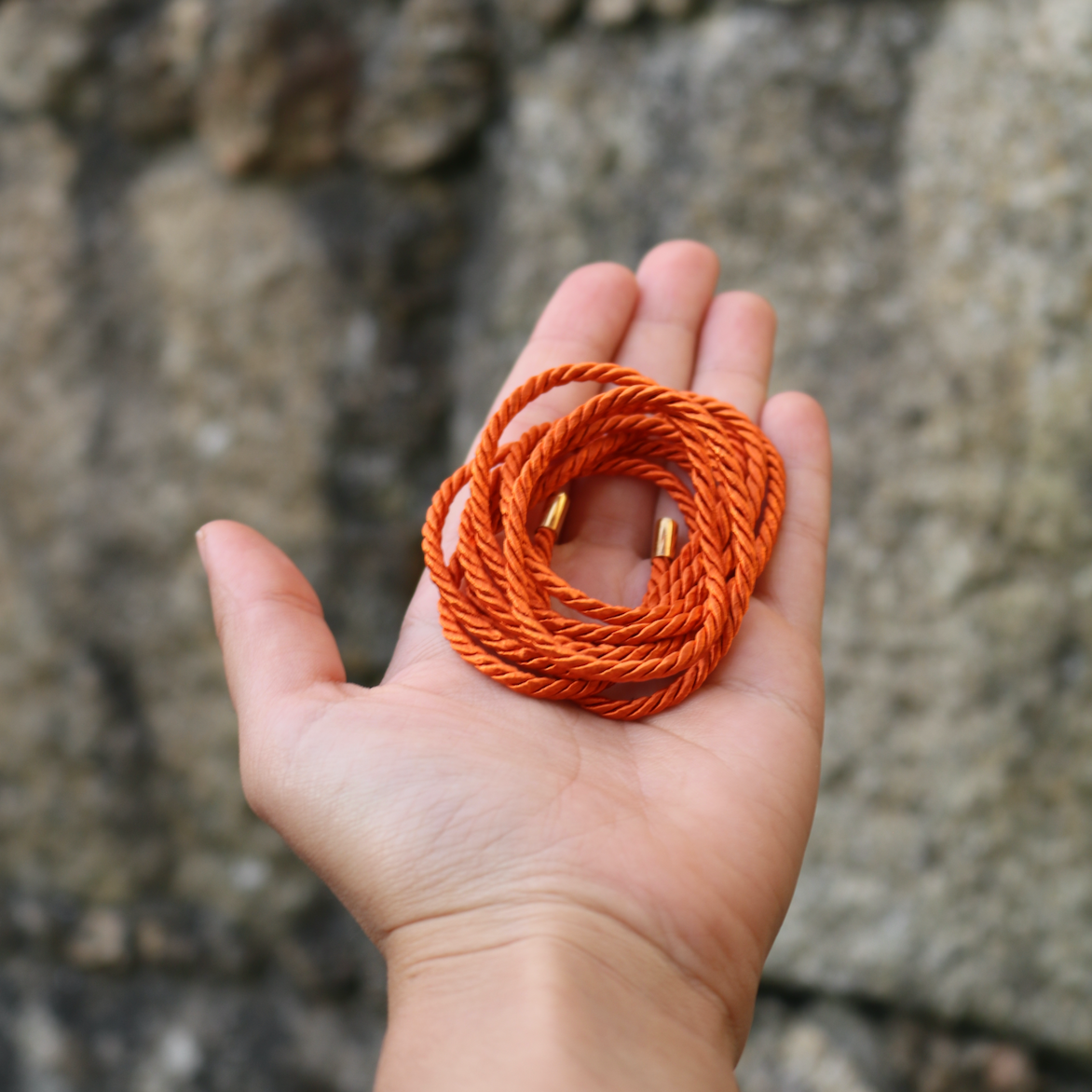 The Orange String & Gold Tips